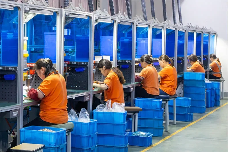Operators assembling electrical components in a workshop