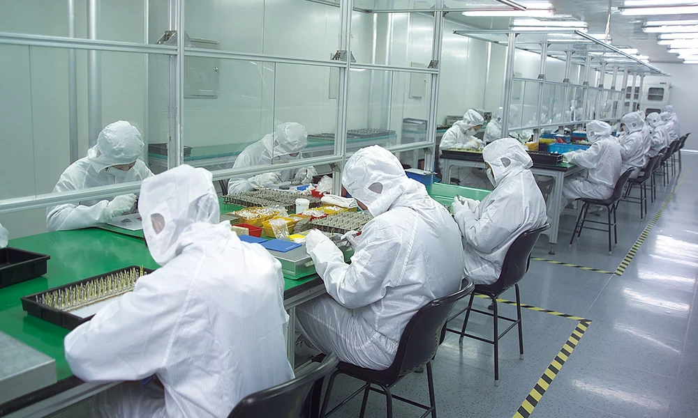 Operators working at semiconductor assembly stations